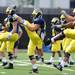 Michigan football players stretch during warm ups at practice on Tuesday.  Melanie Maxwell I AnnArbor.com
